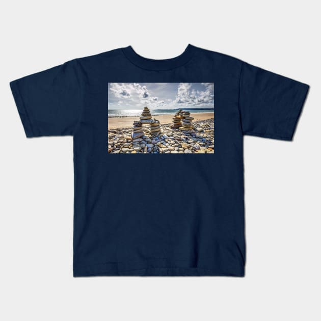 Rock Cairns On Amroth Beach, Wales Kids T-Shirt by tommysphotos